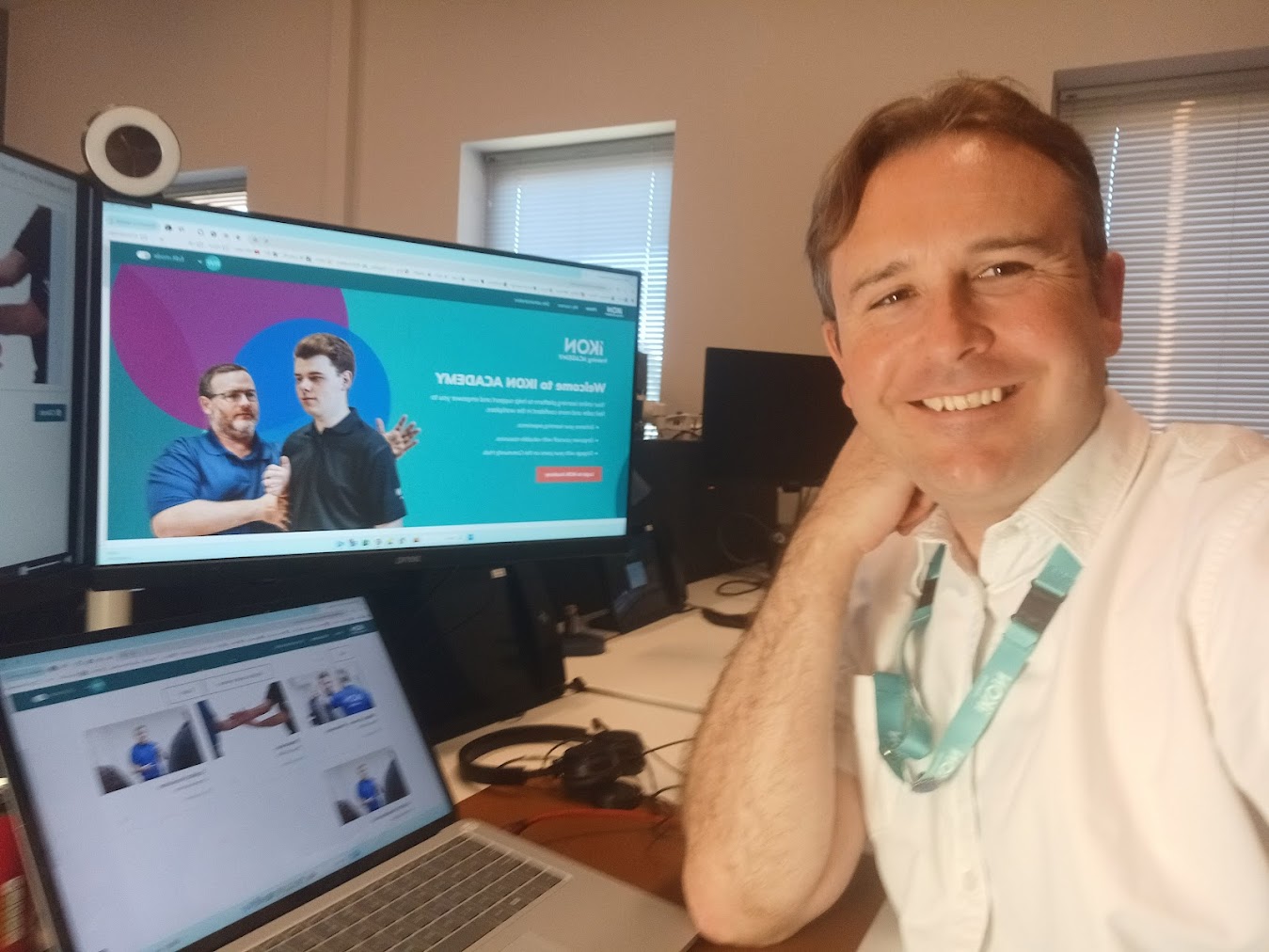 Richard Williams at his desk with the IKON Academy Moodle learning platform visible on screen, working on digital learning data and analytics